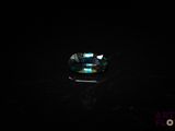 a close up of a ring on a table in the dark