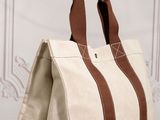 a white and brown bag sitting on top of a wooden table