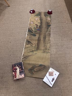 a painting on the floor next to a picture of a woman