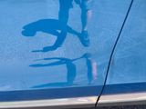 a reflection of a person on the glass of a swimming pool
