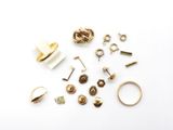 many different types of rings and earrings on a white surface