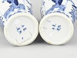 pair of chinese blue and white vases with figures on them