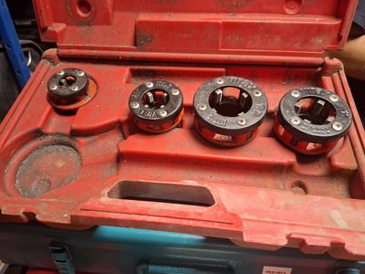 a red tool box with four tools inside of it