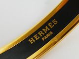 hermes, a gold plated bracelet with black enamel and a black enamel band