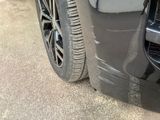 a close up of a car ' s front bumper and tire