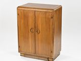 a small wooden cabinet with a door on the front