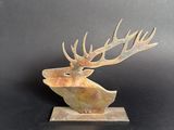 a close up of a sculpture of a deer with antlers on it