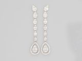 a pair of diamond and white gold earrings