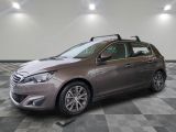 the grey car is parked on a checkered floor in the garage