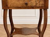 a small wooden table with a drawer on top of it