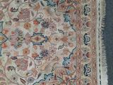 an antique rug with a floral design and fringes on it