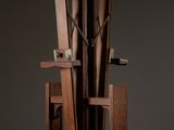 an image of a sculpture made out of wood with a clock on top of it
