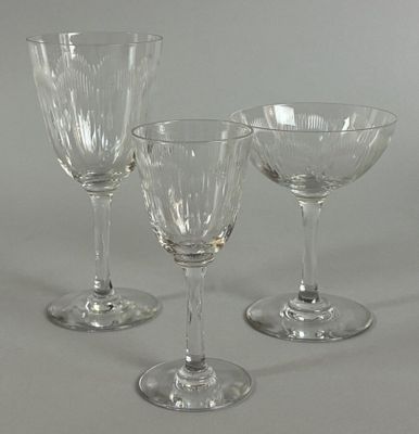 three wine glasses sitting next to each other on a table