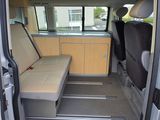 a small van with a bench in the back of it