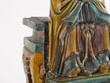 a statue of a woman sitting on a bench