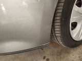 a close up of a car ' s front bumper and tire