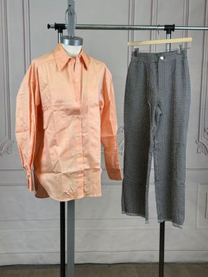 two shirts and pants on a mannequin stand