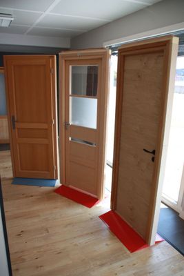 two wooden doors that are open in a room