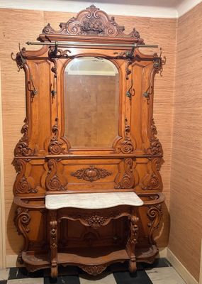 a wooden cabinet with a mirror on top of it