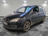 a picture of a small black car parked in a garage