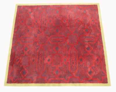 a red rug on a white background with a yellow border