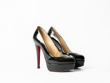 a pair of black high heels on a white surface