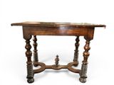 a wooden table with a marble top on wheels