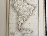 an open book with a map of south america on it
