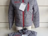 grey jacket with red zippers and tags on a mannequin dummy