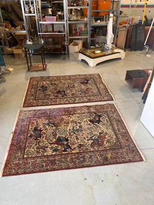 two rugs that are on the floor in a room