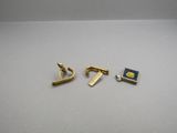 two pairs of gold tone cufflinks with blue and yellow enamel