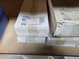 a stack of boxes sitting on a shelf in a room