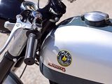 a close up of a motorcycle parked on a gravel road