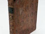 an old book that is sitting on a table