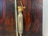 a small wooden box with a glass bottle inside of it