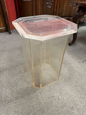 a plastic container sitting on the floor next to a table