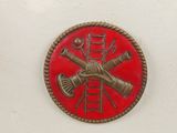 a picture of a red and gold badge on a white sink
