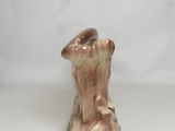 porcelain figurine of a woman holding a vase on a white surface