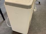 a white cooler sitting on the floor in an office