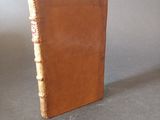 leather bound book on a gray surface with a gray background