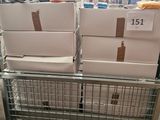 boxes of toilet paper stacked on top of each other in a shopping cart