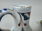 a white pitcher with a blue and white design on it