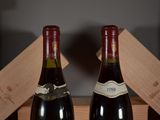 two bottles of wine sitting next to each other on a table