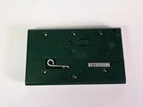 a picture of a green electronic device on a white surface