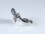 a close up of a silver ring with a flower on it