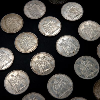 a lot of coins that are on a black surface