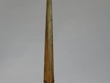 a tall wooden object on a stand on a white surface