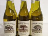 three bottles of wine sitting on top of a table next to each other
