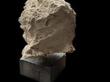 a close up of a stone sculpture on a black surface