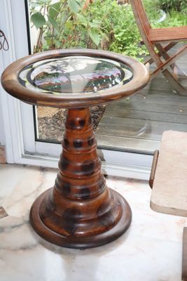 a small table with a glass top in a room